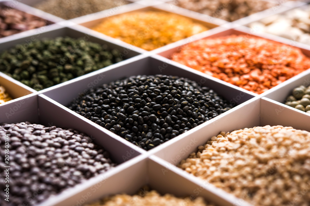 Indian Beans,Pulses,Lentils,Rice and Wheat grain in a white wooden box with cells, selective focus. Indian Beans,Pulses,Lentils,Rice and Wheat grain in a white wooden box with cells, selective focus.
