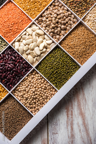 Indian Beans,Pulses,Lentils,Rice and Wheat grain in a white wooden box with cells, selective focus.