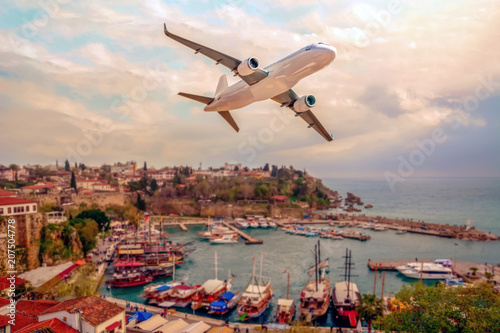 Fototapeta Naklejka Na Ścianę i Meble -  Passenger plane flying over the city . Old town (Kaleici) in Antalya, Turkey