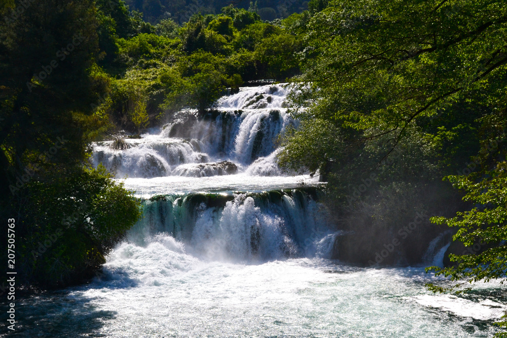 Fototapeta premium Waterfalls flowing down a river