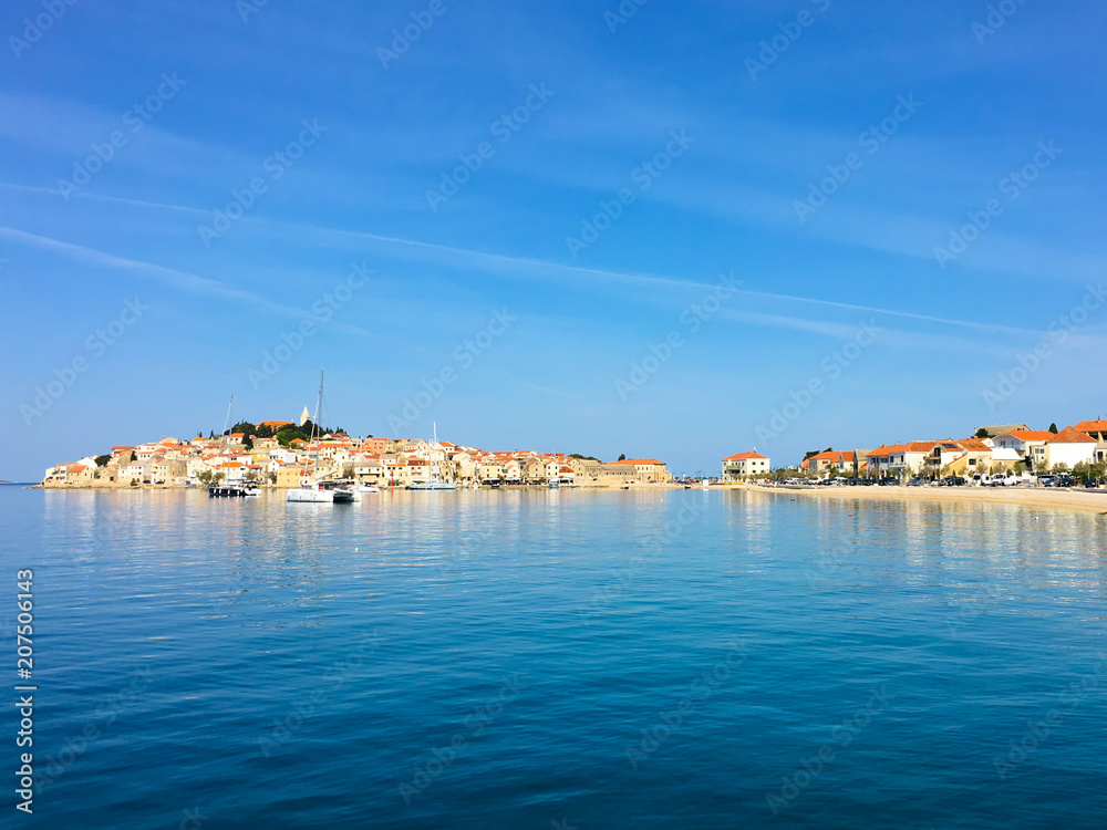 The town of Primosten across the blue ocean, Croatia