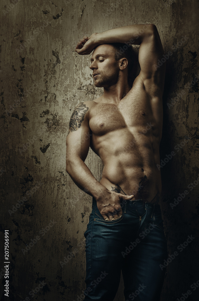 Young muscular and sexy man with tattoos posing in different poses