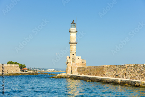 Lighthouse in the historical venetian port of Chania. The greek city on the north coast of Crete is one of the most beautiful towns on the island	