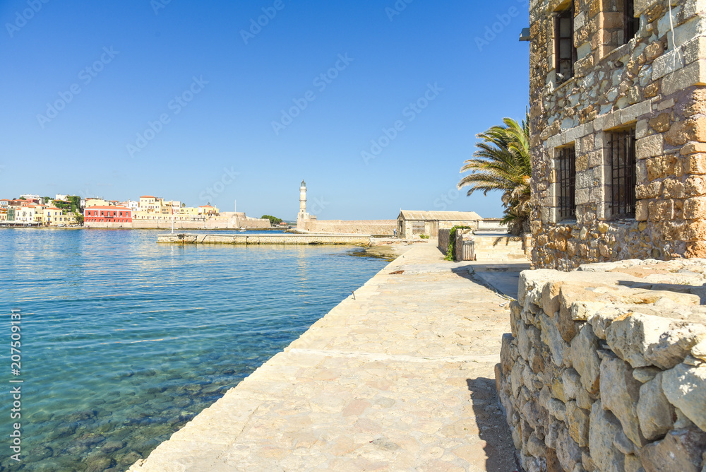 Historical harbor buildings and lighthouse in the venetian port of Chania