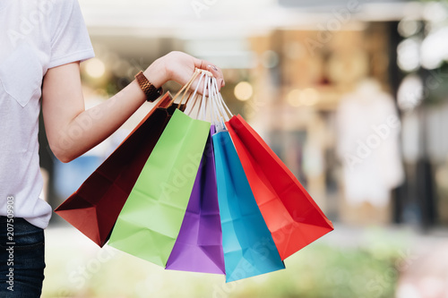 Young woman happy with shopping bags. Easy E-commerce Website Shop by Smartphone, iPhone, iPad and Laptop. Business and modern lifestyle concept