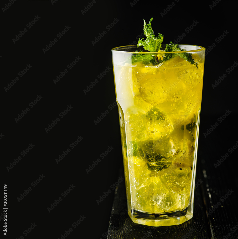 Ice lemonade with mint and lemon in a Casablanca glass. Copyspace. Ice lemonade with mint and lemon in a Casablanca glass. Copyspace.