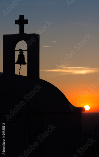 Silhouetted Greek church at sun set