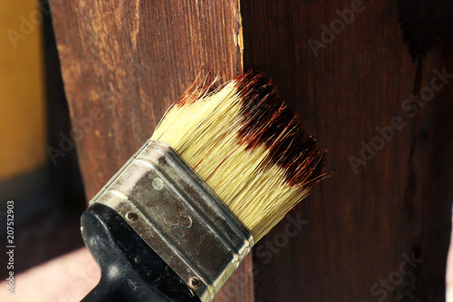 The painter who painting wooden board with small brush photo