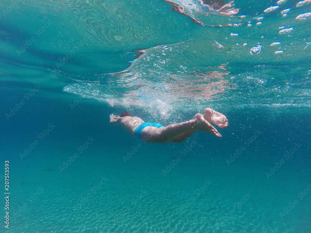 young man swim in the sea