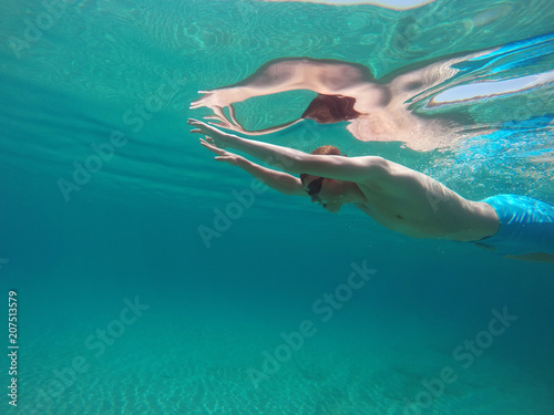 young man swim in the sea