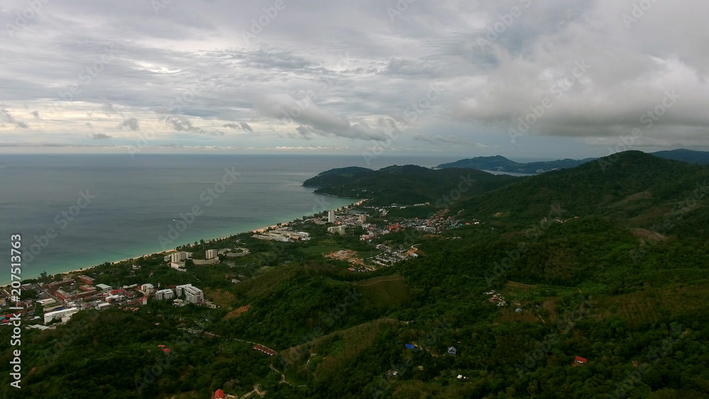 Flying over city near the beach in Phuket