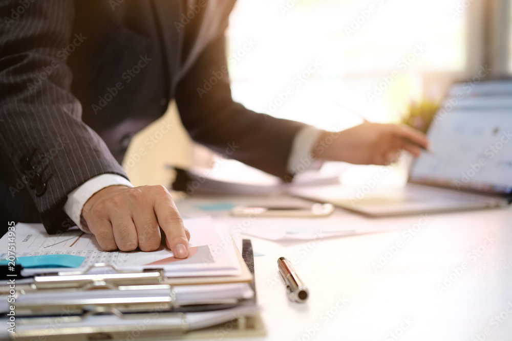 Businessman working with digital computer in modern office with virtual icon diagram at modern office in morning light Businessman working with digital computer in modern office with virtual icon diagram at modern office in morning light