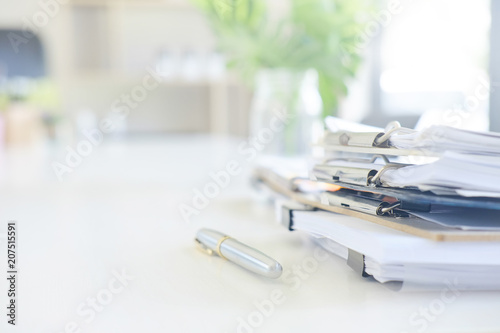 фотографія Stack of paper files and pen business equipment on office table.