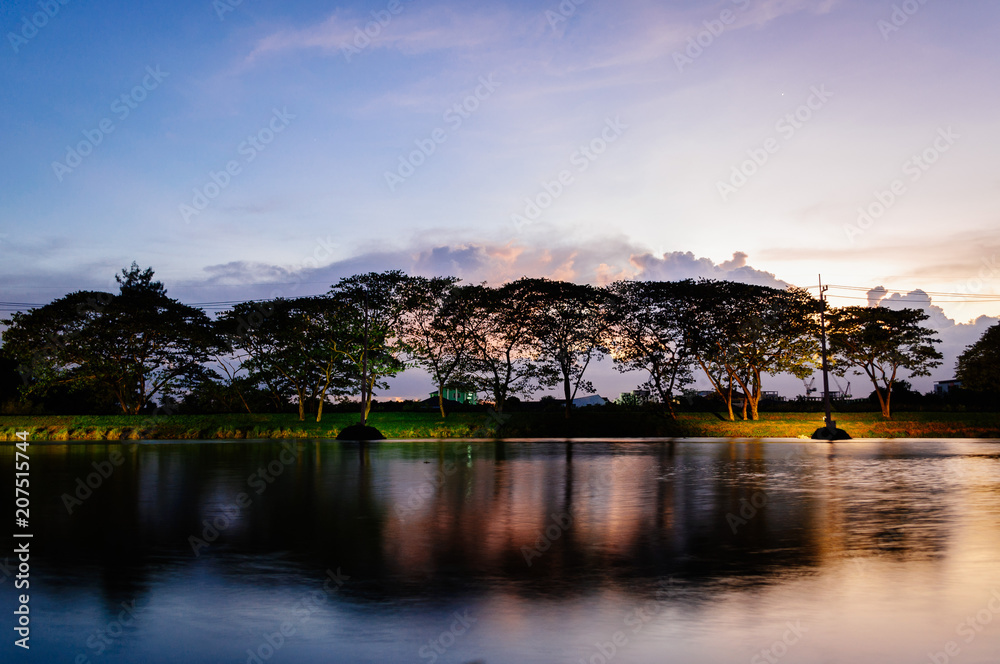 Obraz premium A small lake in summer , at sunset