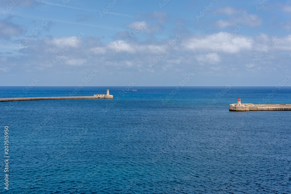 Photo of Mediterranean Sea, view from Valletta, Malta. Blue cloudy sky as background.