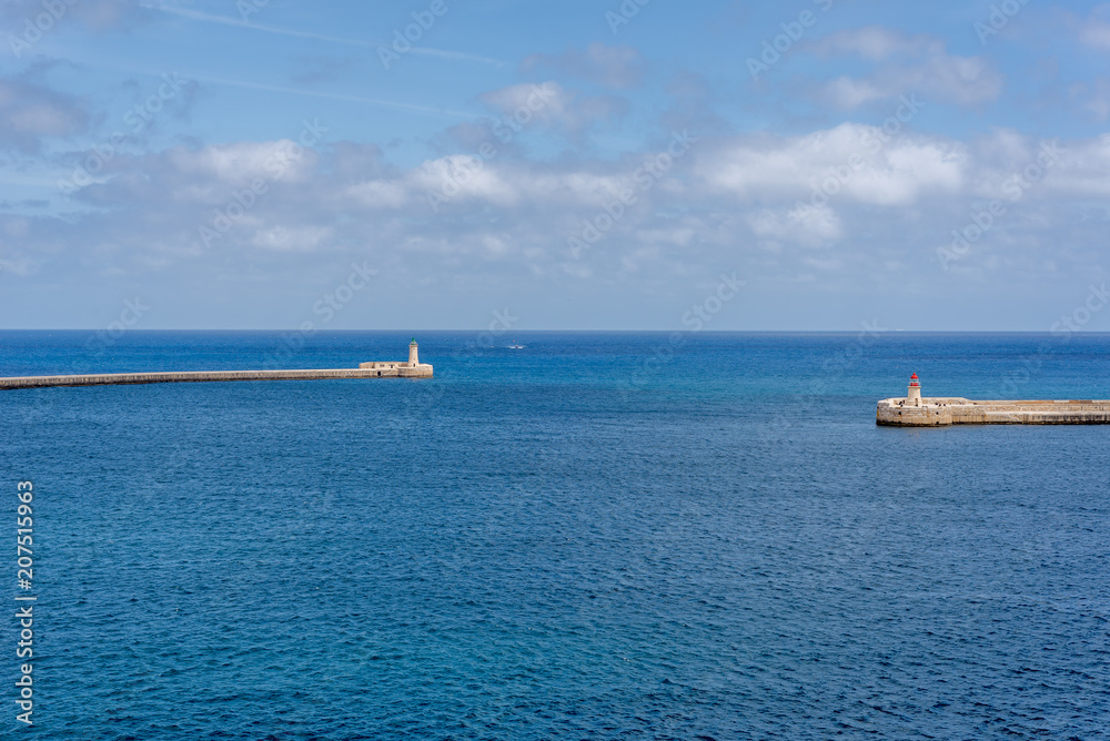 Photo of Mediterranean Sea, view from Valletta, Malta. Blue cloudy sky as background. Photo of Mediterranean Sea, view from Valletta, Malta. Blue cloudy sky as background.