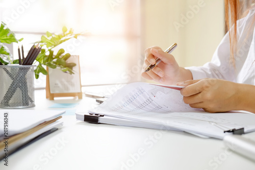 Audit woman check document data financial in paper.