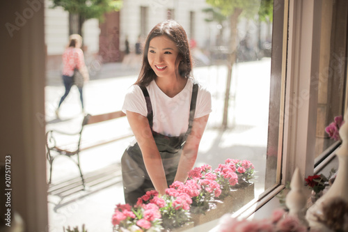 Smiling woman taking care of flowers photo