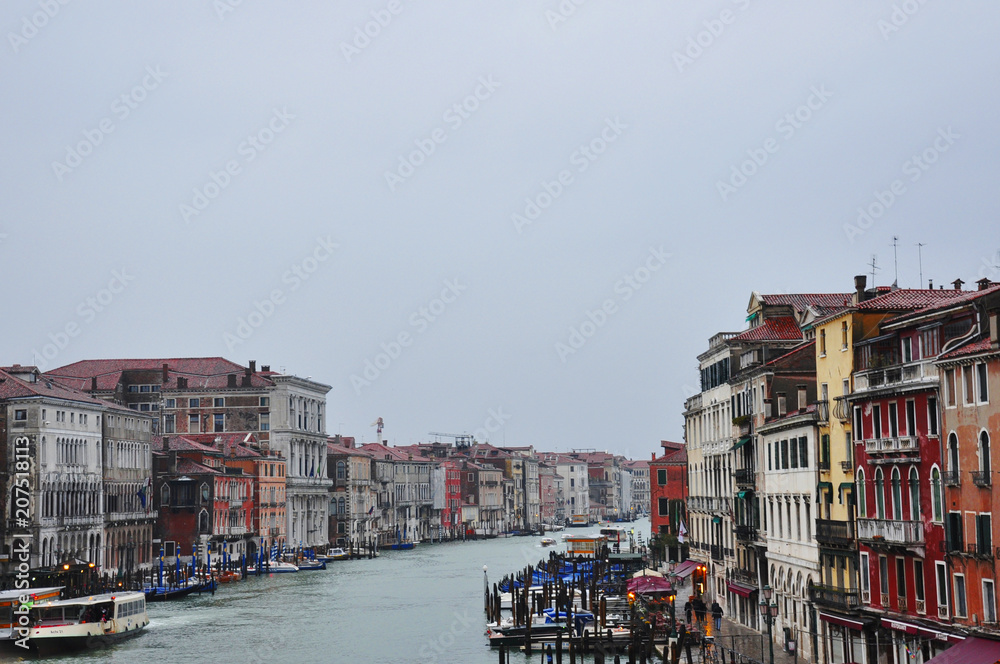 Canal with gondolas in Venice. Historical old buildings above the river in Italy. European cityscape