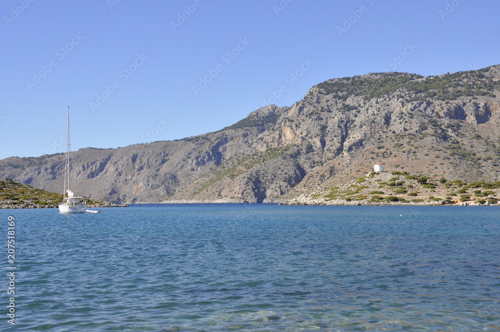 Landscape of the Greece coastline. View on the yacht in the port and the blue ocean. European tourism. Seascape