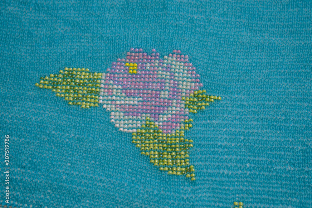 Fototapeta premium Beaded embroidery on the woolen schally