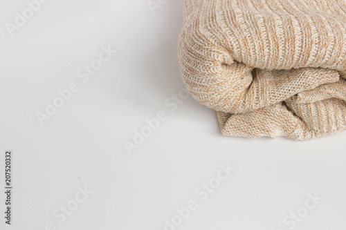 Soft home knitted plaid on white background, beige cozy fabric large knit texture