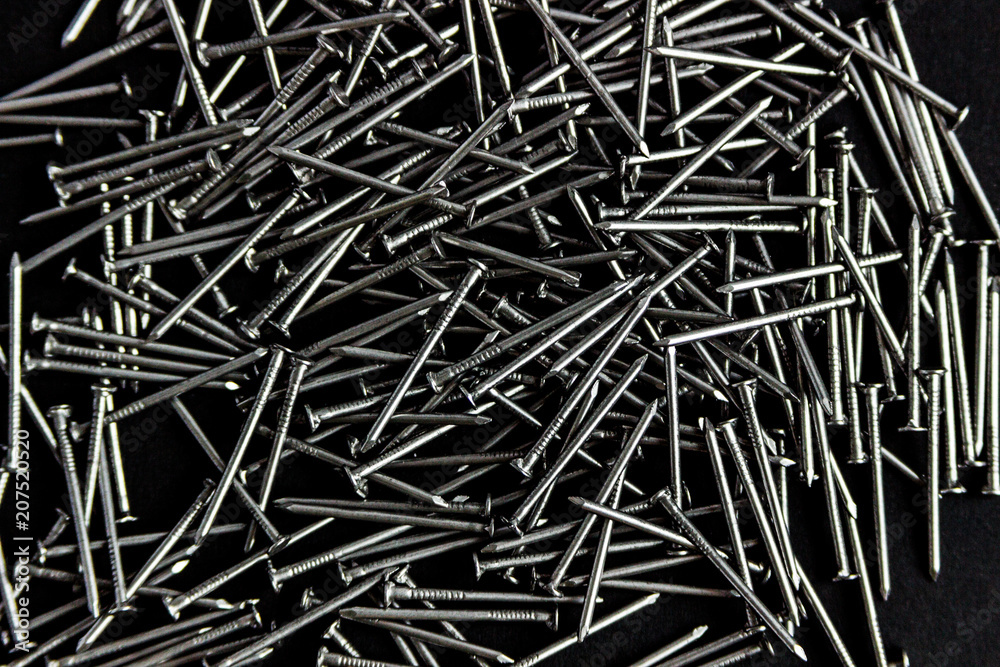 metal nails scattered on a black background