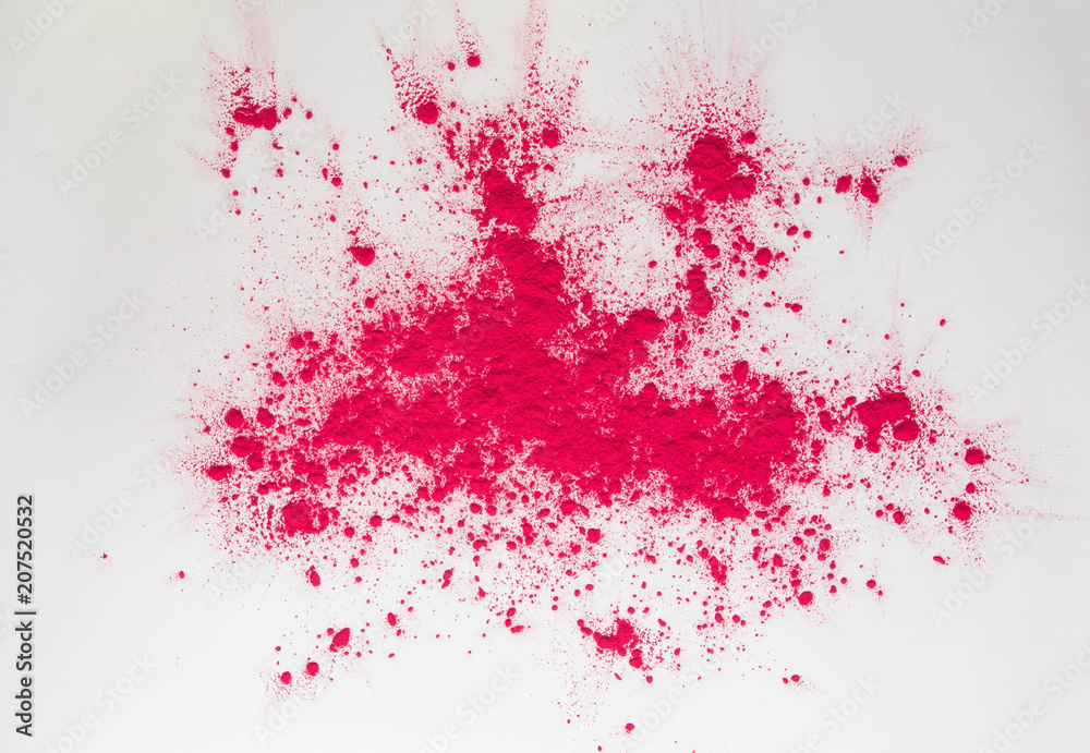 scattered pink dye powder on white background