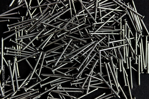 metal nails scattered on a black background