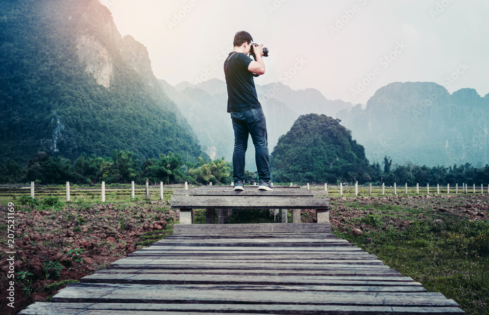 photographer taking photos in front of the mountain. photographer taking photos in front of the mountain.