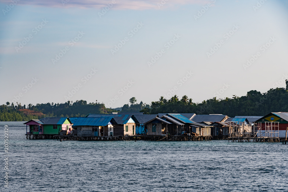 houses on stilts in Yellu village at sunset, east Misool, Indonesia