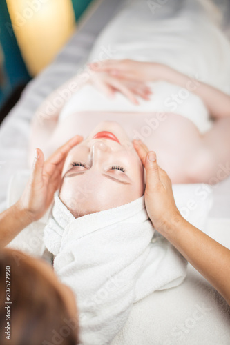 Bild auf Leinwand Adult european wealthy woman getting anti-aging face-lifting massage relaxing after working day