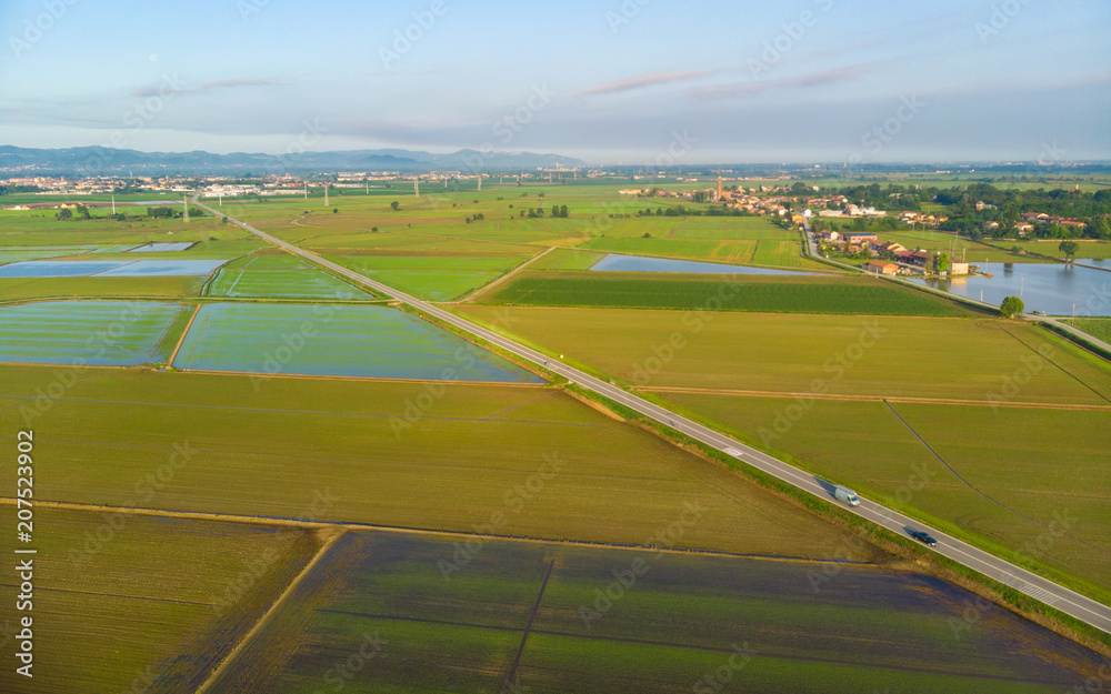 Aerial: rice paddies, flooded cultivated fields farmland rural italian countryside, agriculture occupation, sprintime in Piedmont, Italy