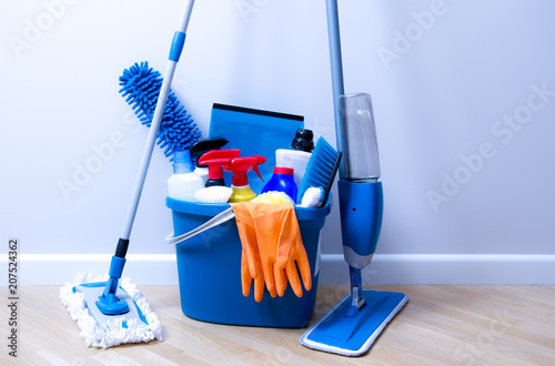 Cleaning service. Bucket with sponges, chemicals bottles and mopping stick.  Household equipment.