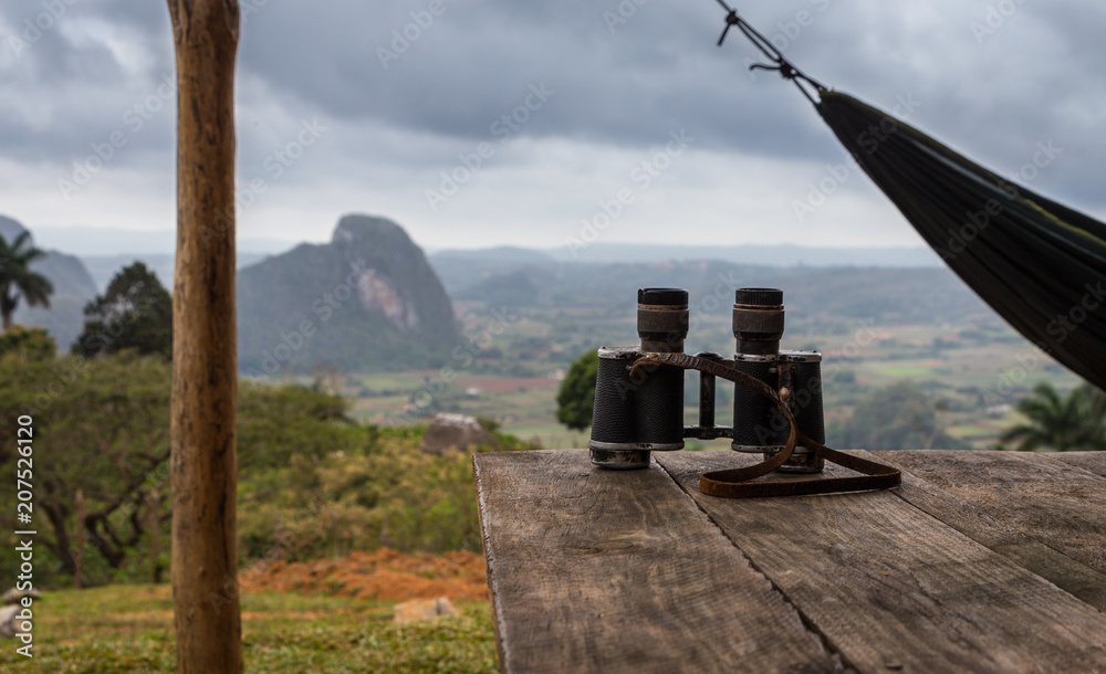Binoculars on a wooden table in the mountains