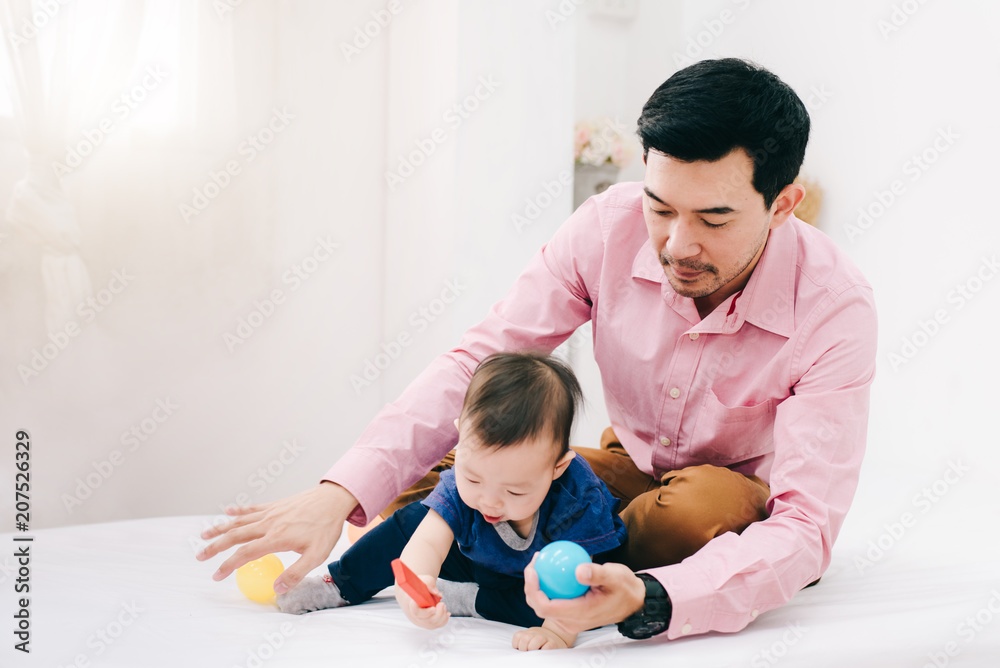 Happy Asian Family , Father Playing with Baby Boy in White Living Room - Lifestyle Concept Happy Asian Family , Father Playing with Baby Boy in White Living Room - Lifestyle Concept