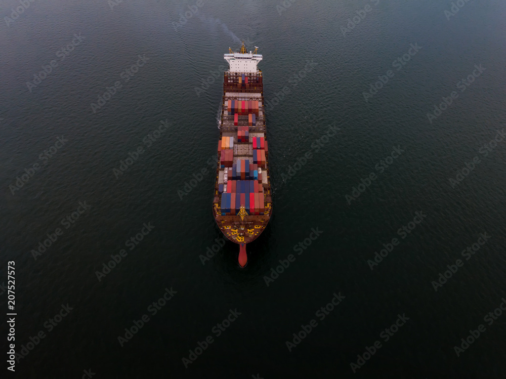 Cargo container ship sailing alone on the black ocean for export freight shipping by ship concept.