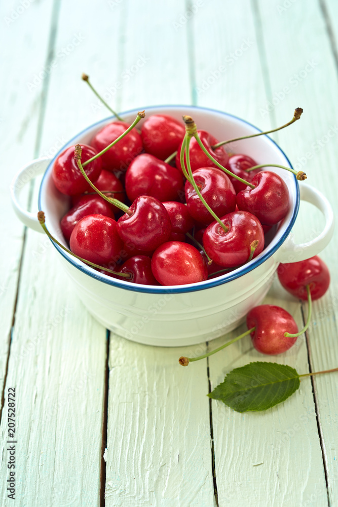 Fresh juicy cherries in white bowl Fresh juicy cherries in white bowl