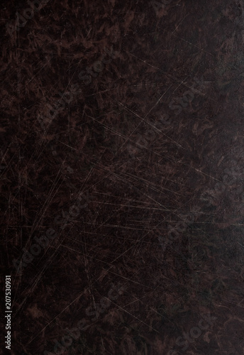 Old dark brown wooden background with scratches. Table texture.