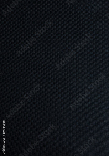 Black notebook is lying on wooden background. Sketch book texture. Vertical photo.