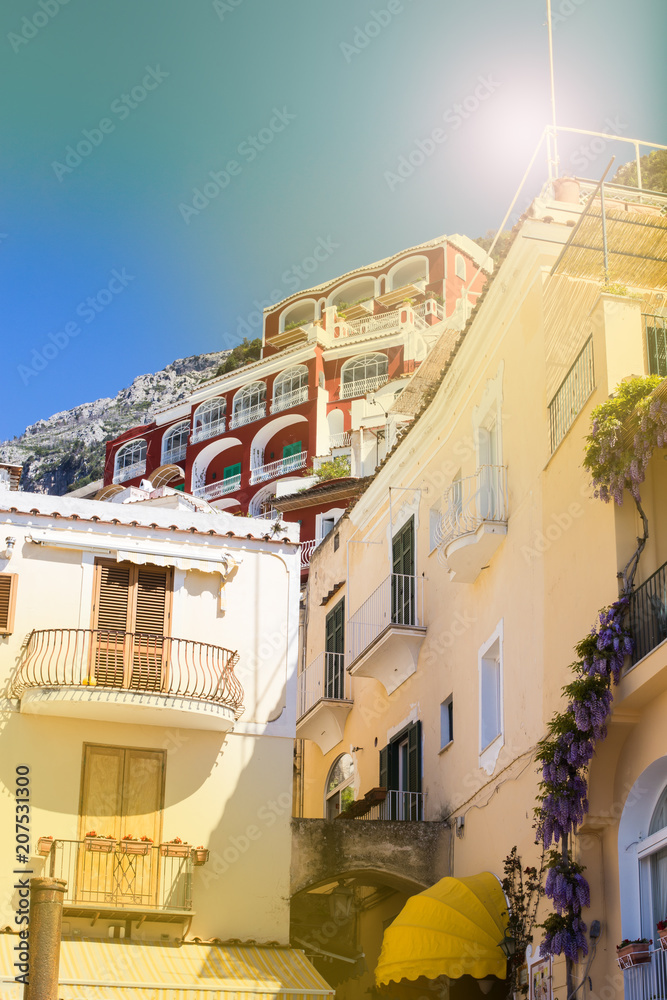 Traditional Italian architecture. Houses on the mountains of Positano Amalfi Coast in the sunshine - architectural and tourist background.