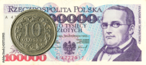 10 polish groszy coin against 100000 polish zloty bank note