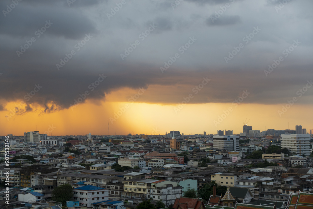 Storm with beautiful sunset in the city.