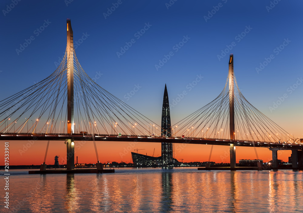 Cable-stayed bridge Betancourt and the tower of Lakhta center, at sunset, Saint-Petersburg, Russia