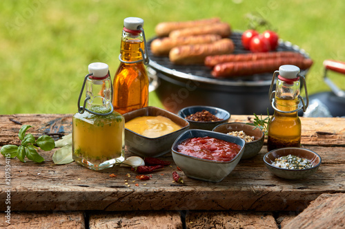 Obraz na plátně Assorted condiments and spices on a picnic table