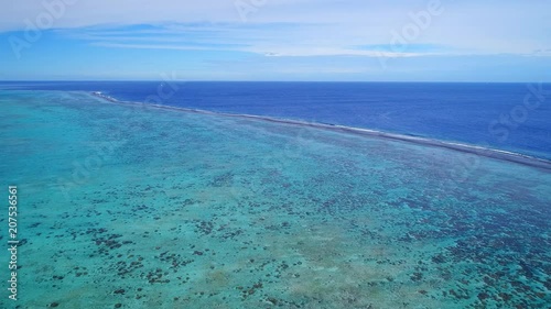 Aerial view of coral barrier reef, turquoise crystal clear water of blue lagoon, tropical paradise of South Pacific Ocean - Motu Tautau, Tahaa island, seascape of French Polynesia photo