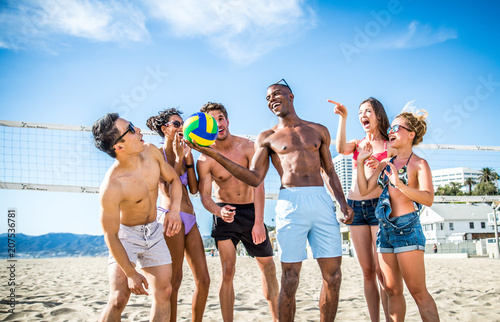 Friends play beach volley
