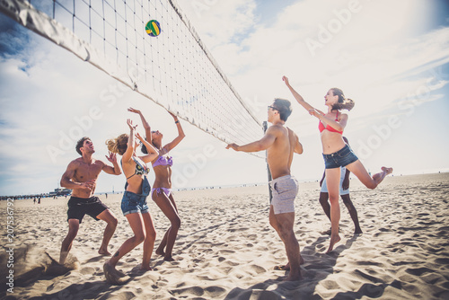 Friends play beach volley