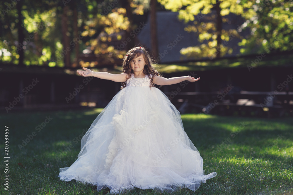 Outdoor portrait of cute fashionable girl wears boater decorated