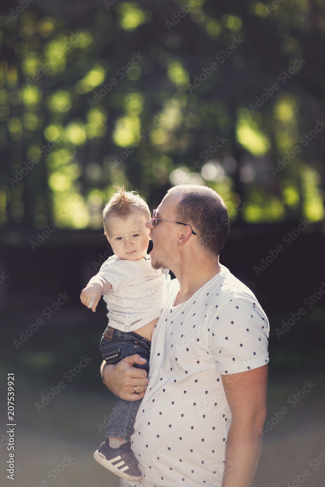 Father and son playing in the park at the sunset time. Father and son playing in the park at the sunset time.